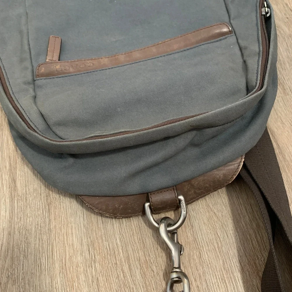 Coach 2013 canvas sling backpack in navy blue w/ brown leather panels - 13x18in‎